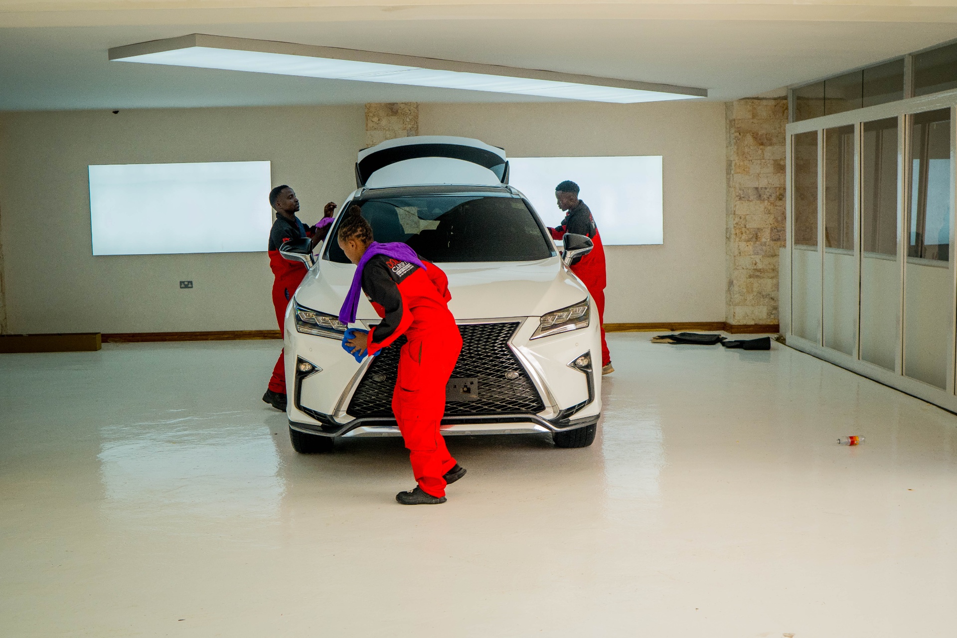 Three Donga technicians polishing a Lexus RX F-Sport