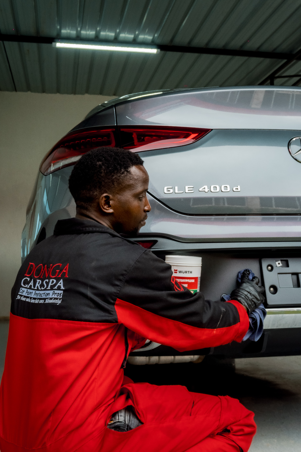 Technician detailing Mercedes GLE 400d rear