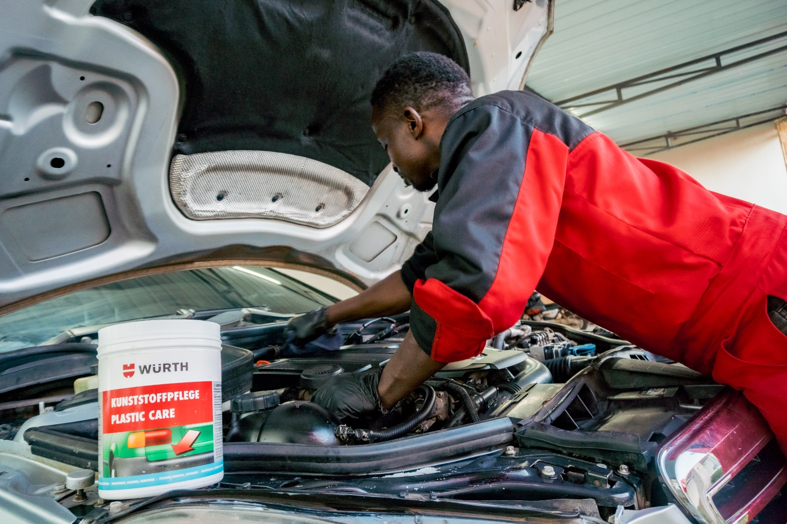 Donga technician applying Würth plastic care under hood